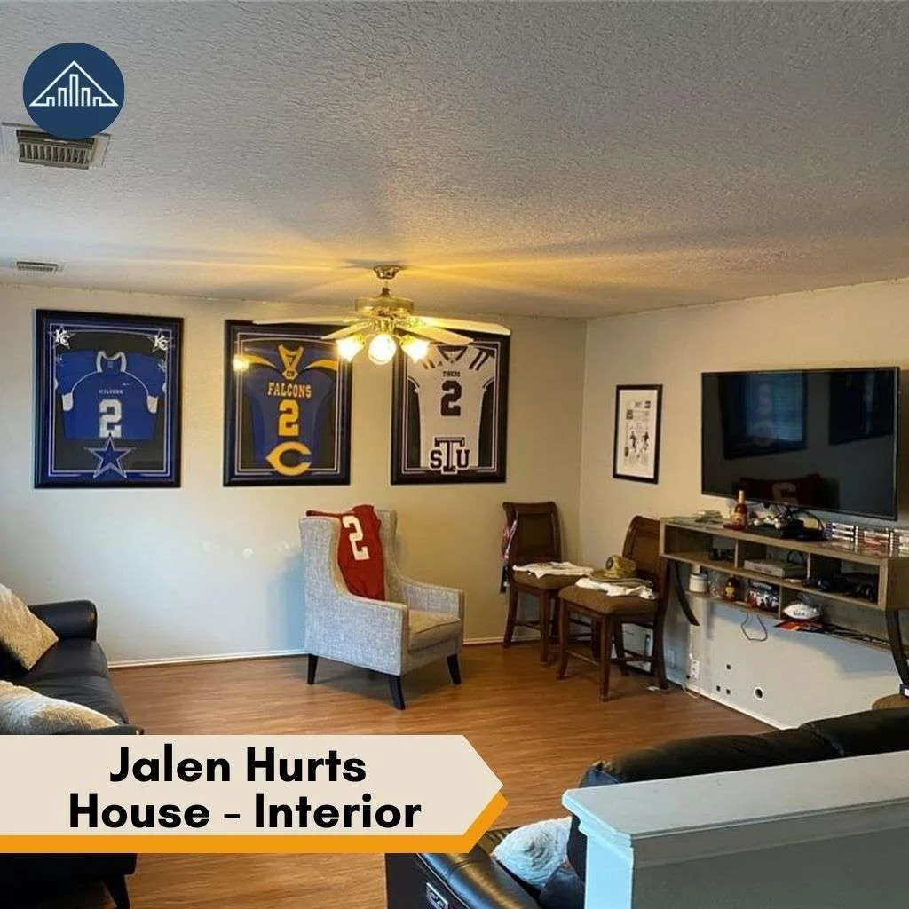 A cozy living area featuring framed sports jerseys on the wall inside the Jalen Hurts house.