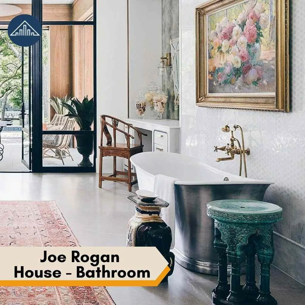 Luxurious bathroom in the Joe Rogan House featuring a metallic tub, floral art, and elegant decor.