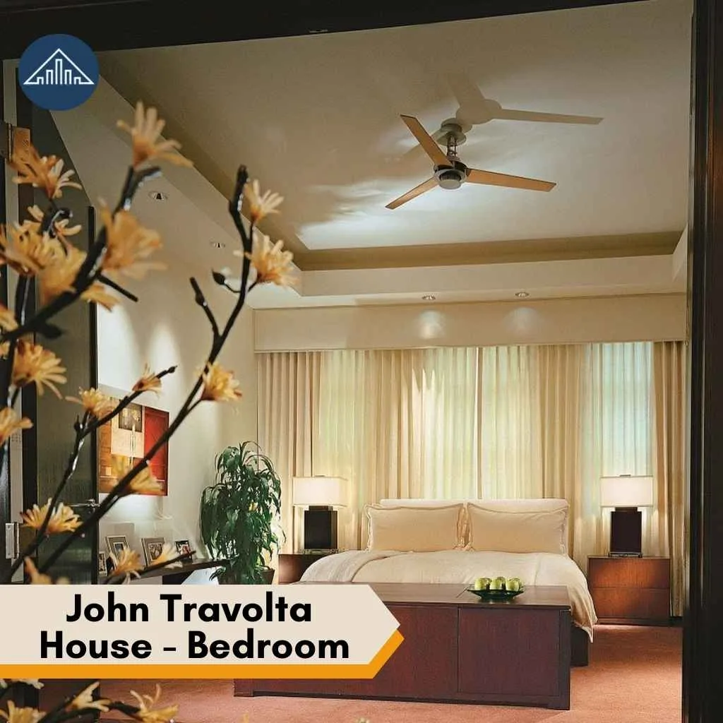 An elegant, warm bedroom interior featuring a modern ceiling fan inside the luxury John Travolta house.