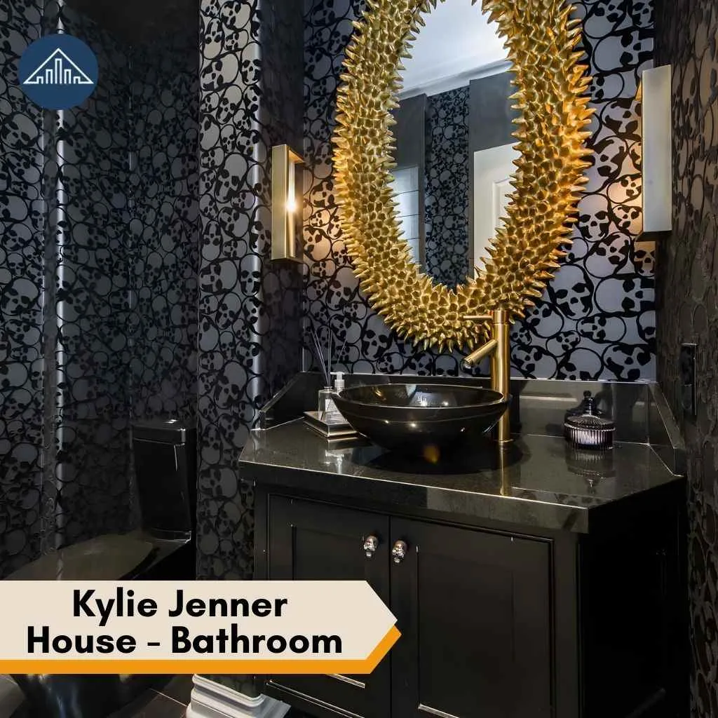 Edgy bathroom in the Kylie Jenner House with skull wallpaper, black vanity, and gold spiked mirror.