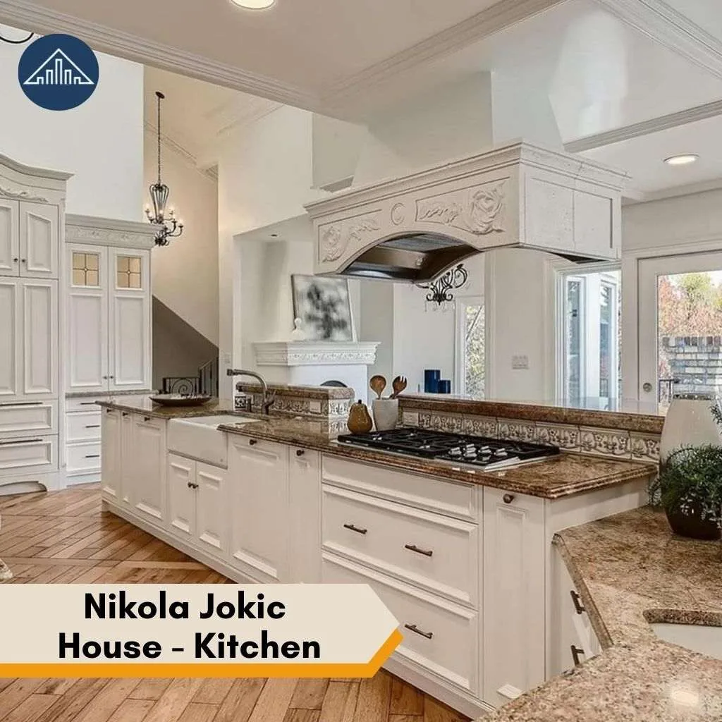 A bright, elegant kitchen featuring ornate white cabinetry inside the luxurious Nikola Jokic house property.
