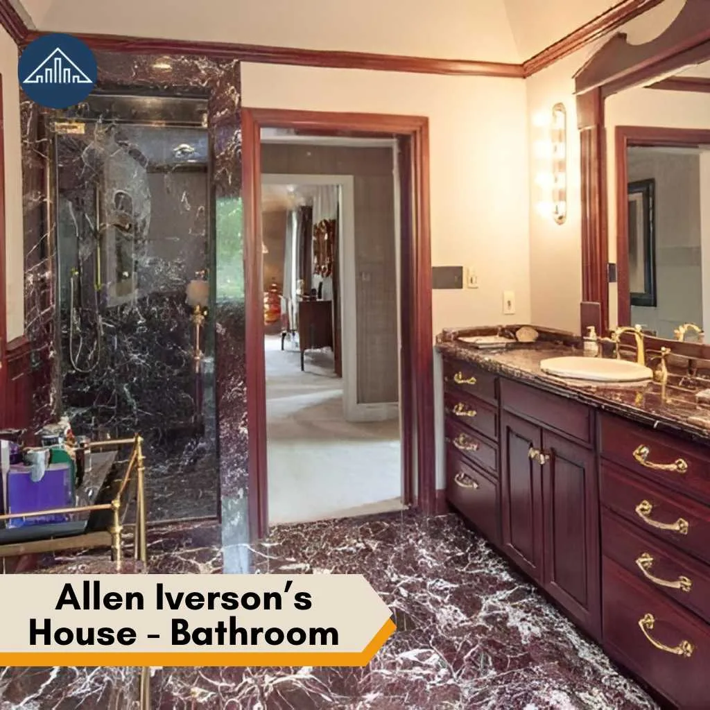 Luxurious marble finishes and dark wood cabinetry define this elegant bathroom inside the Allen Iverson house.
