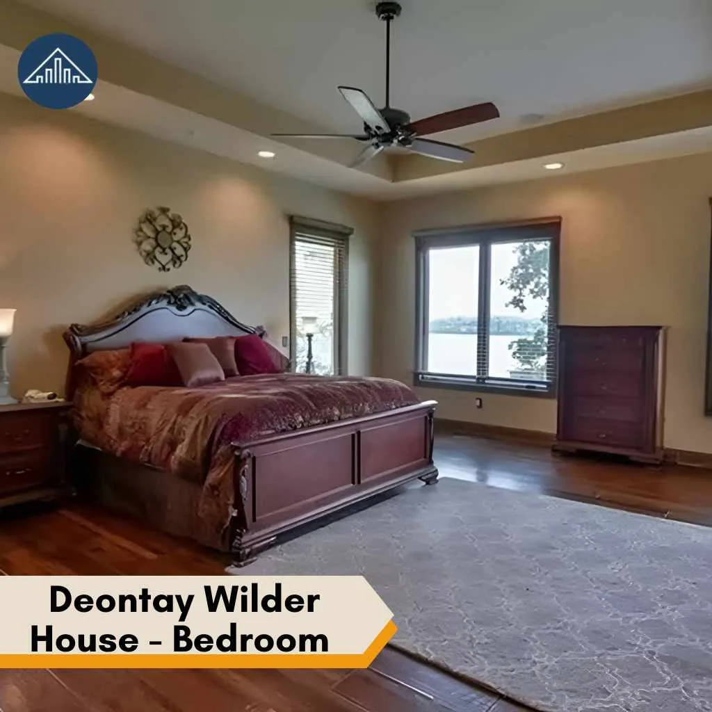 A traditional style bedroom within the deontay wilder house featuring a large dark wood bed.