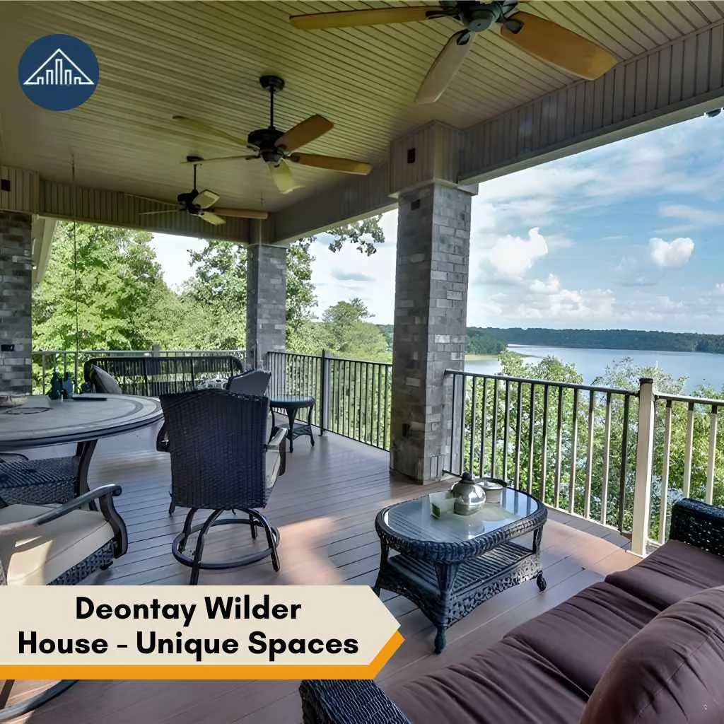A spacious outdoor deck at the deontay wilder house overlooking a serene, wide blue lake.
