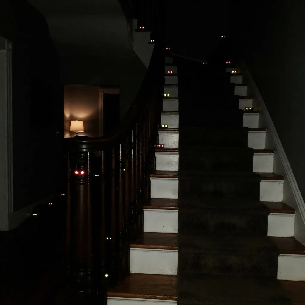 15 Halloween Staircase Decor Ideas That Will Steal the Show 12 11. Glowing Eyes in the Shadows